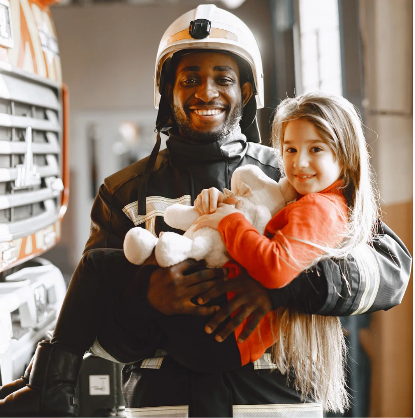 firefighter holding a child
