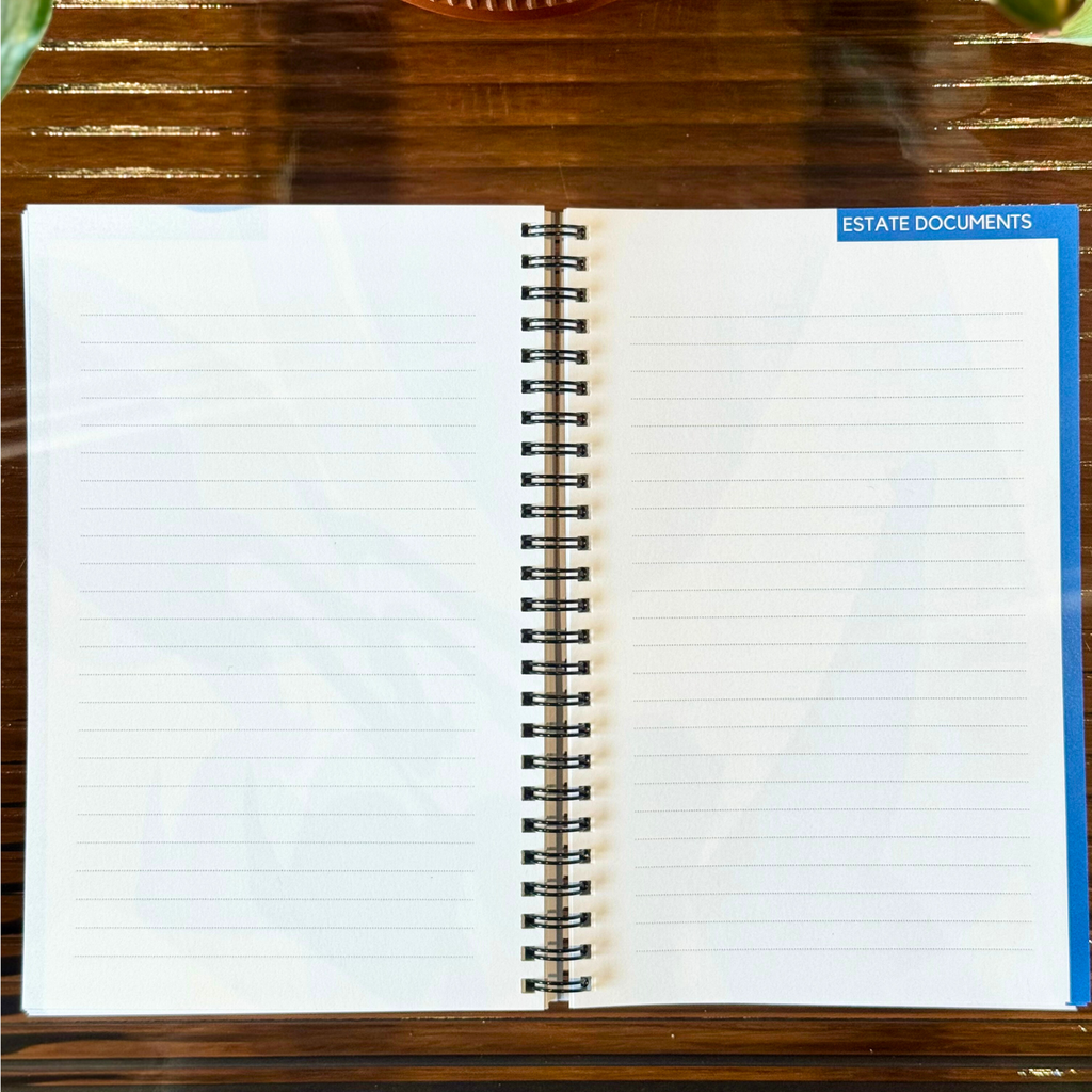 Open notebook on a wooden surface with plants in the background