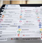 Close-up of Nokbox folder tabs labeled Legal, Insurance, Investments, Medicare, Mortgage or Lease, and more